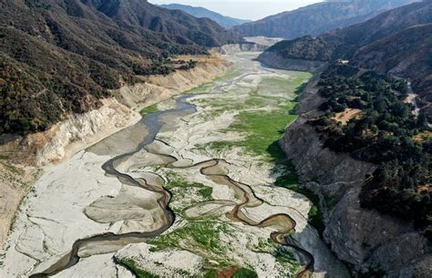 In An Aerial View The San Gabriel River And The Exposed Lakebed Of