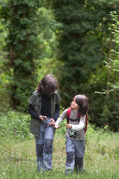 Nature S Secrets Unveiled Elder Sibling Enlightening Younger Brother In A Forest Clearing Stock